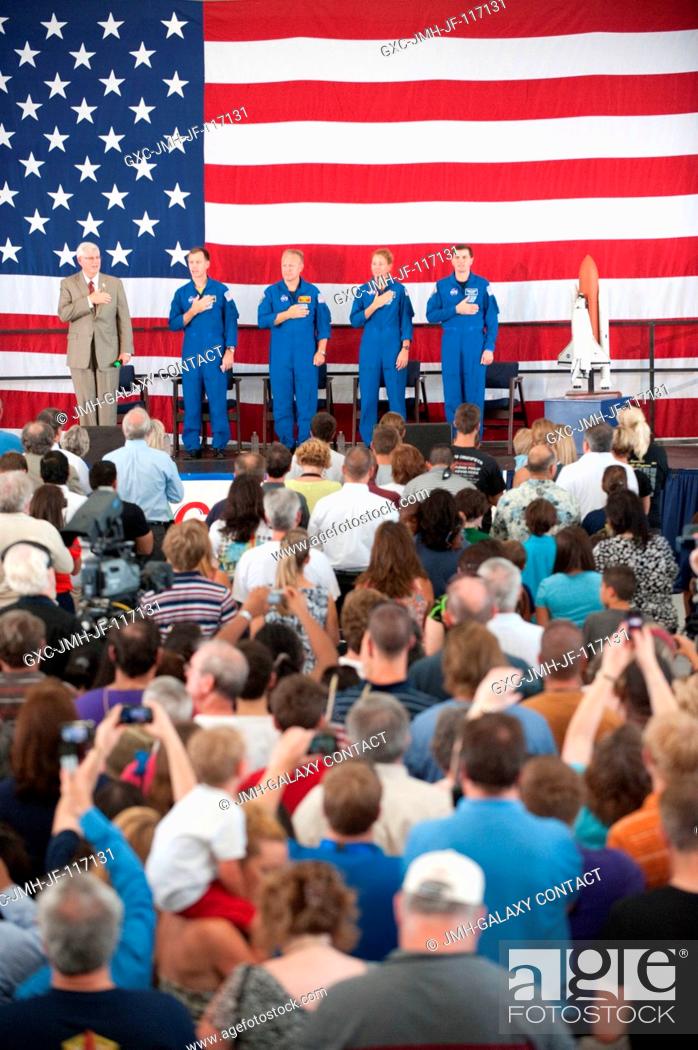 Stock Photo: NASA's Johnson Space Center (JSC) director Michael L. Coats (left) and STS-135 crew members are pictured during the STS-135 crew return ceremony on July 22.