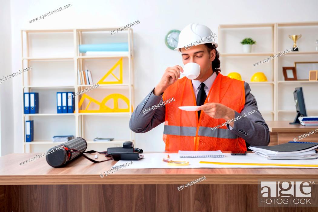 Stock Photo: The young male architect working in the office.