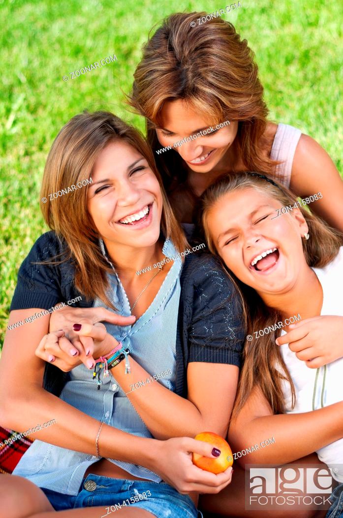 Stock Photo: Happy mother with her daughters in park outdoors.