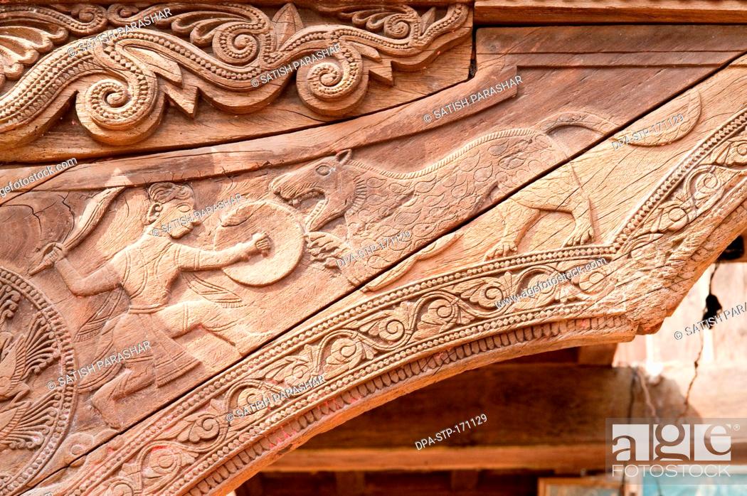 Stock Photo: Hunting of tiger wooden carving on someshwar temple at Rajwadi , Sangmeshwar , Ratnagiri , Maharashtra , India.