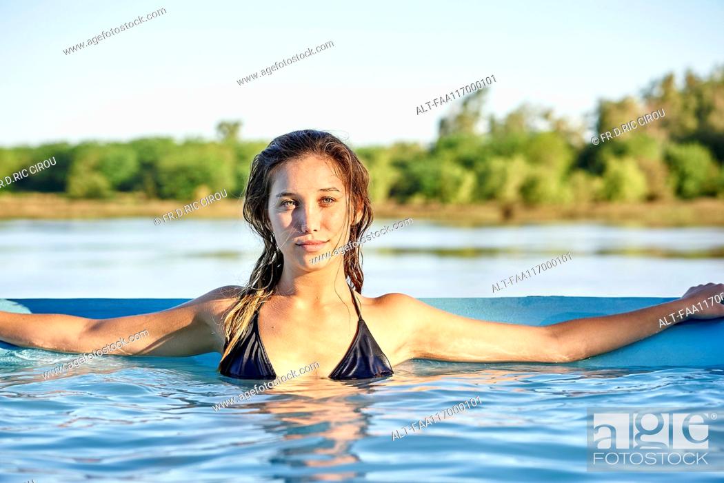 Stock Photo: Portrait of young woman in swimming pool.