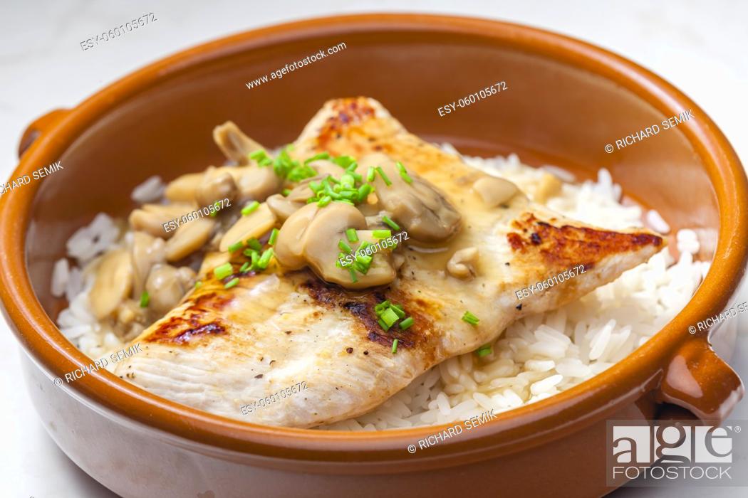 Stock Photo: grilled turkey fillet with mushroom sauce and rice.