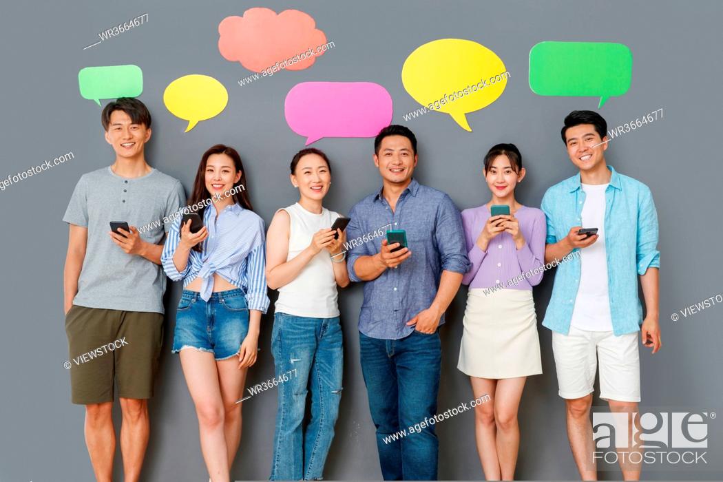 Stock Photo: In the happy young people use mobile phone chat software to communicate.