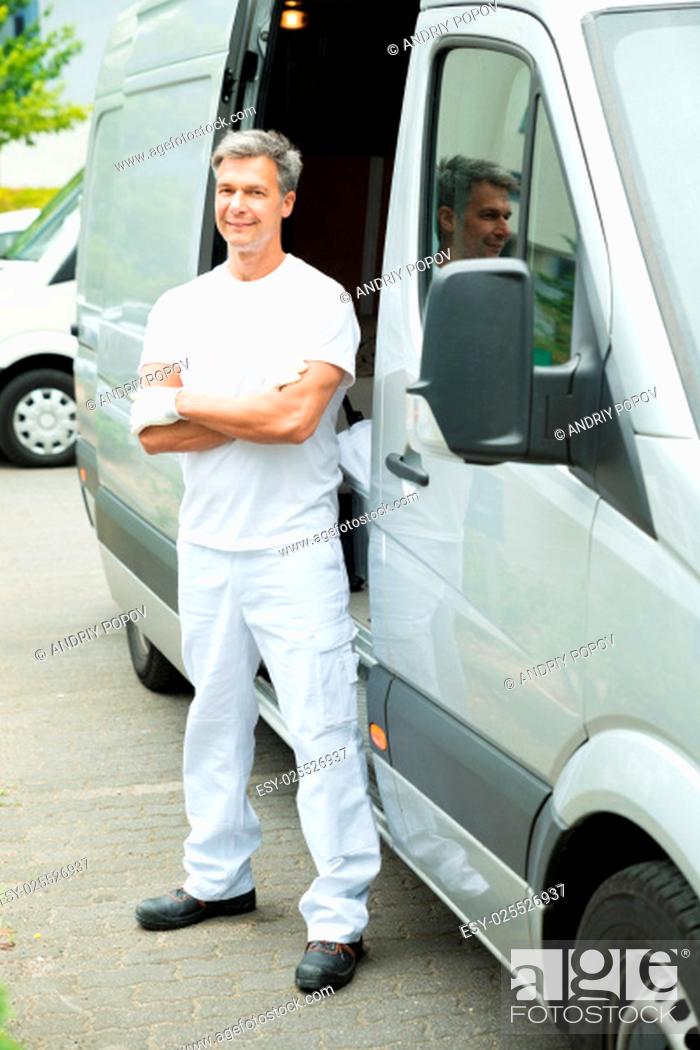 Stock Photo: Happy Male Painter With Arms Crossed Standing In Front Of Van.