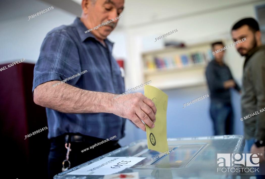 Stock Photo: A man comes out of a polling booth with his ballot at a polling station in Istambul, Turkey, 16 April 2017. Turkish citizens are voting on a constitutional.