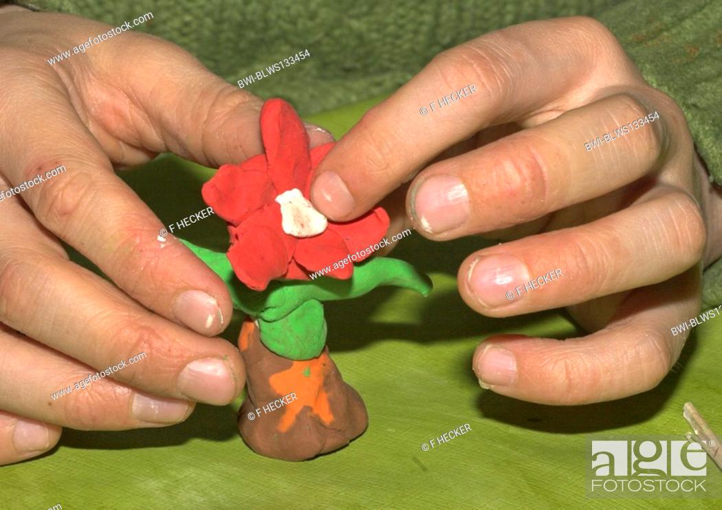 Stock Photo: kids tinker flowers of modeling clay.