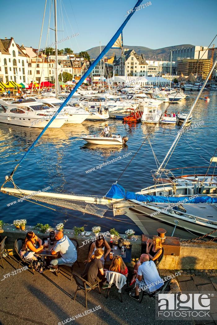 Stock Photo: Outdoor terrace of XL Diner restaurant, and View of Harbour, Brosundet, Alesund, More og Romsdal, Norway.