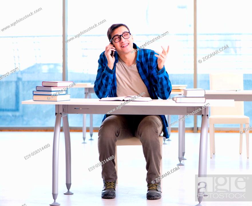 Stock Photo: Student studying in the empty library with book preparing for exam.
