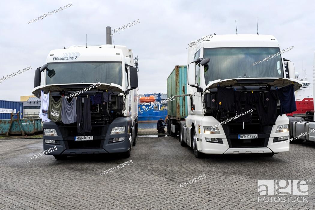 Stock Photo: Rotterdam, Netherlands. Polish Truck Drivers cleaning their Laundry using their Truck's Engine, wile waiting inside a Merwe Harbor's Fruit Terminal's Parking.