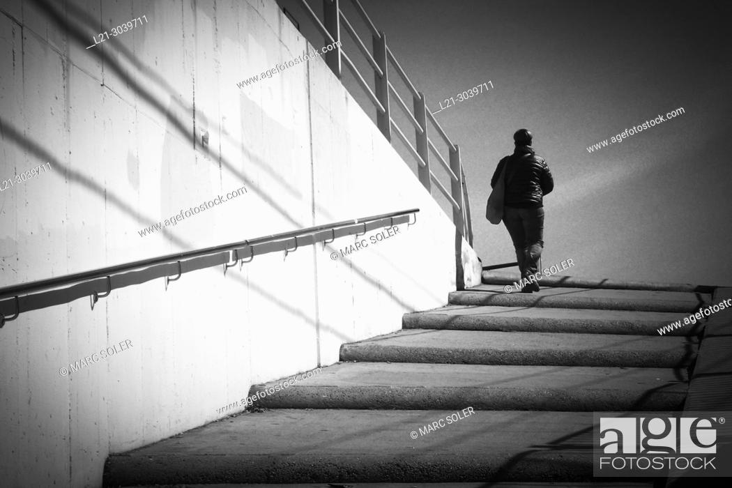 Stock Photo: Person climbing up some stairs. Barcelona province, Catalonia, Spain.