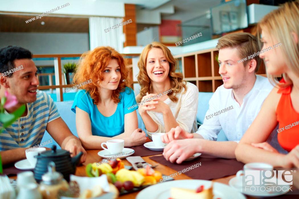 Stock Photo: Portrait of happy teenage friends spending time in cafe.