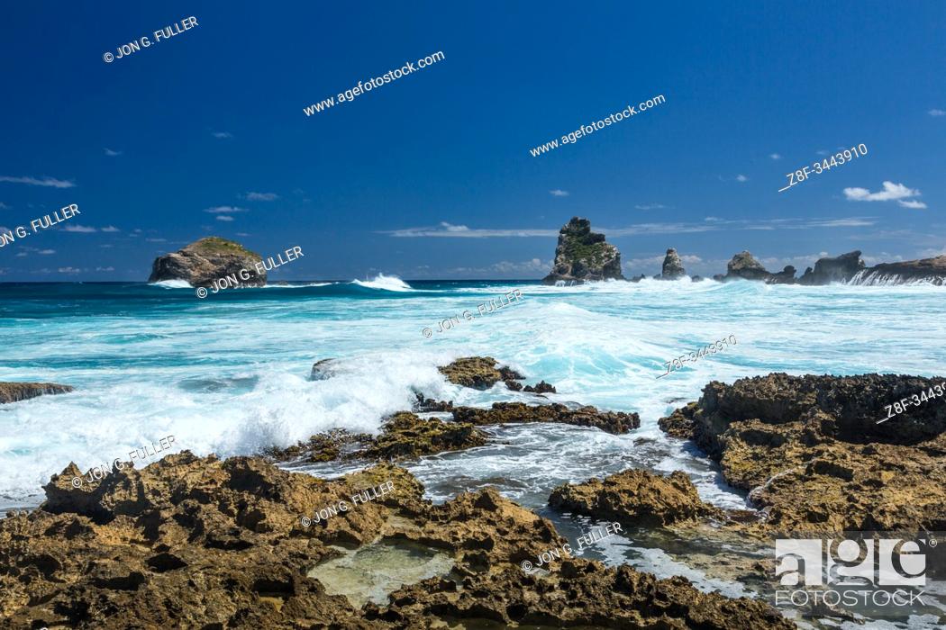 Stock Photo: Waves from the Atlantic Ocean crash on the limestone shore of the peninsula of Pointe des Chateaux on the island of Grande-Terre, Guadeloupe.