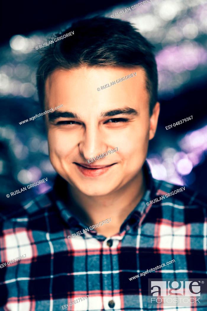 Stock Photo: portrait of a young man on a blurred background.