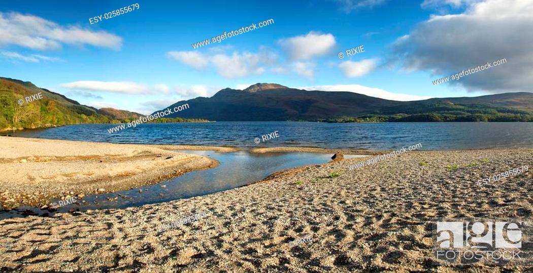 Stock Photo: Panorama of a small shingle beach at the edge of Loch Lomond, Scotland.