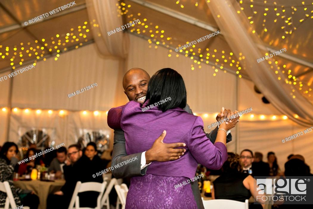 Stock Photo: Black groom dancing with mother at reception.