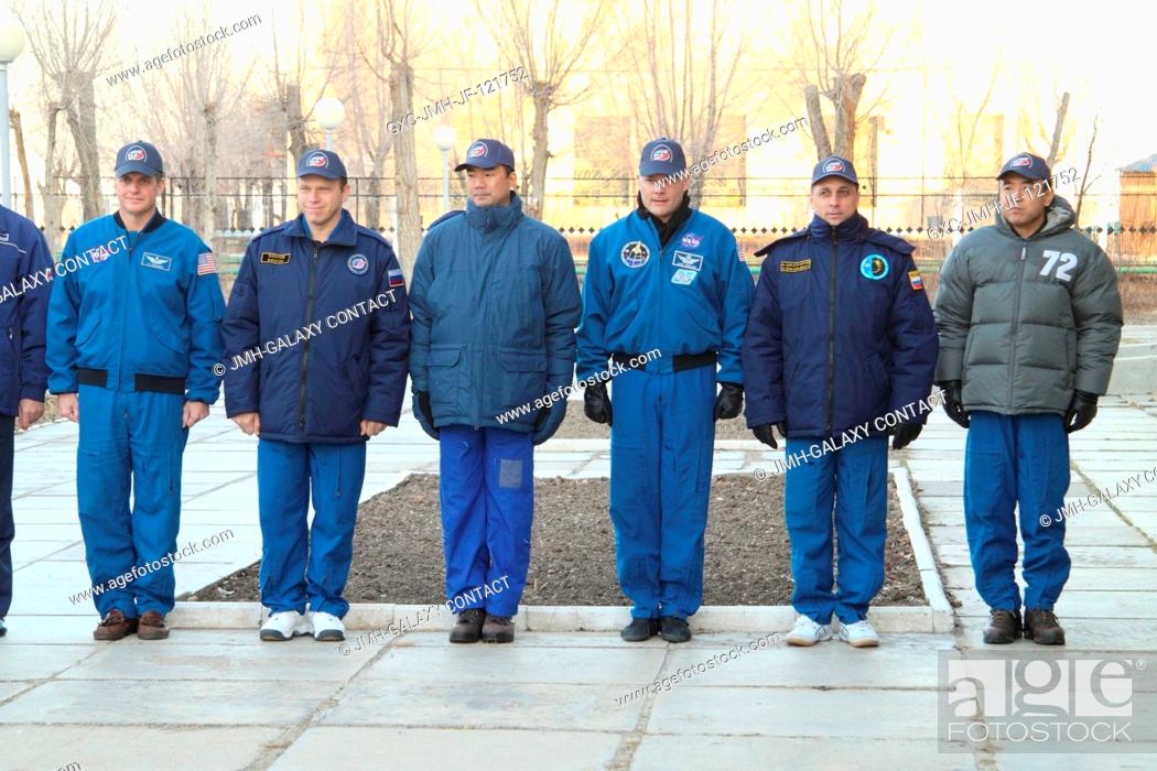 Stock Photo: At their Cosmonaut Hotel crew quarters in Baikonur, Kazakhstan, the Expedition 22 prime and backup crews attend ceremonies for the raising of American, Russian.