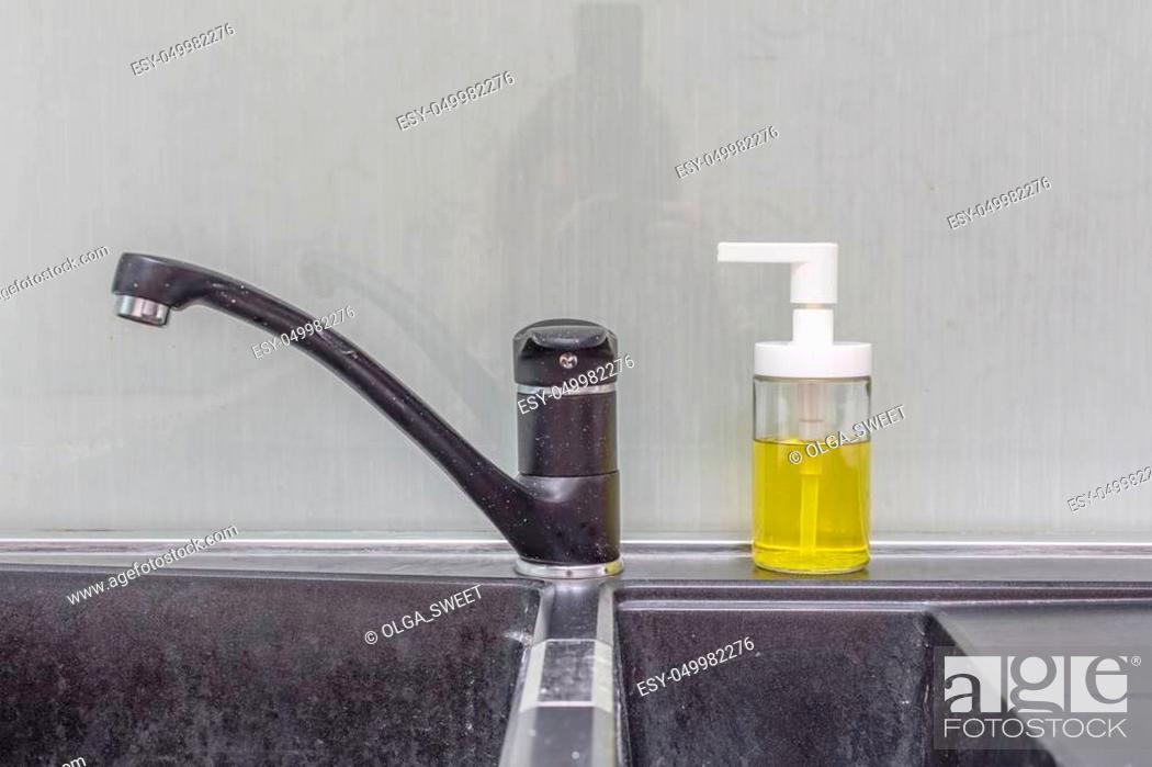 Stock Photo: Close up of modern faucet and ceramic sink in kitchen.