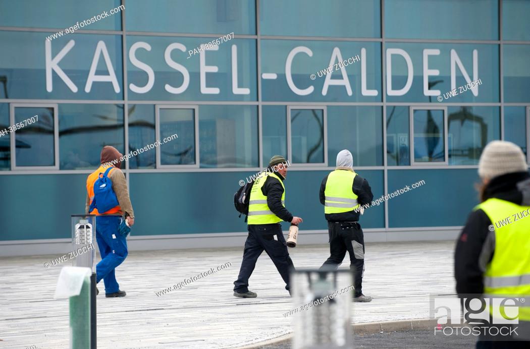 Stock Photo: Construction workers walk past the terminal of Kassel Calden Airport in Calden, Germany, 03 April 2013. After about 15 years of planning.