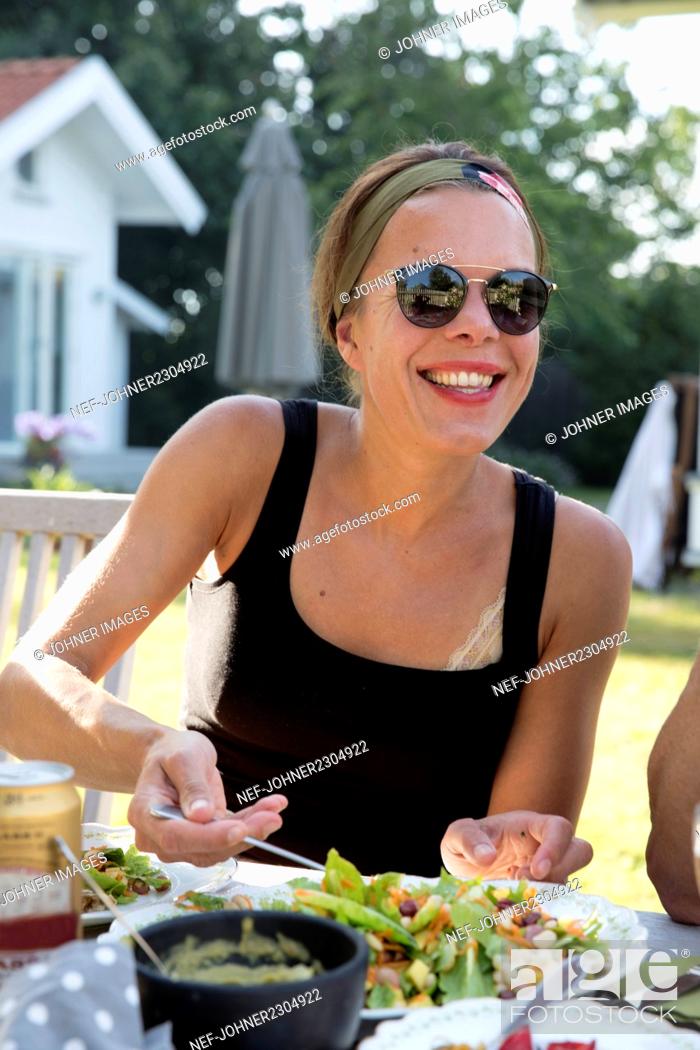 Stock Photo: Smiling woman at table.