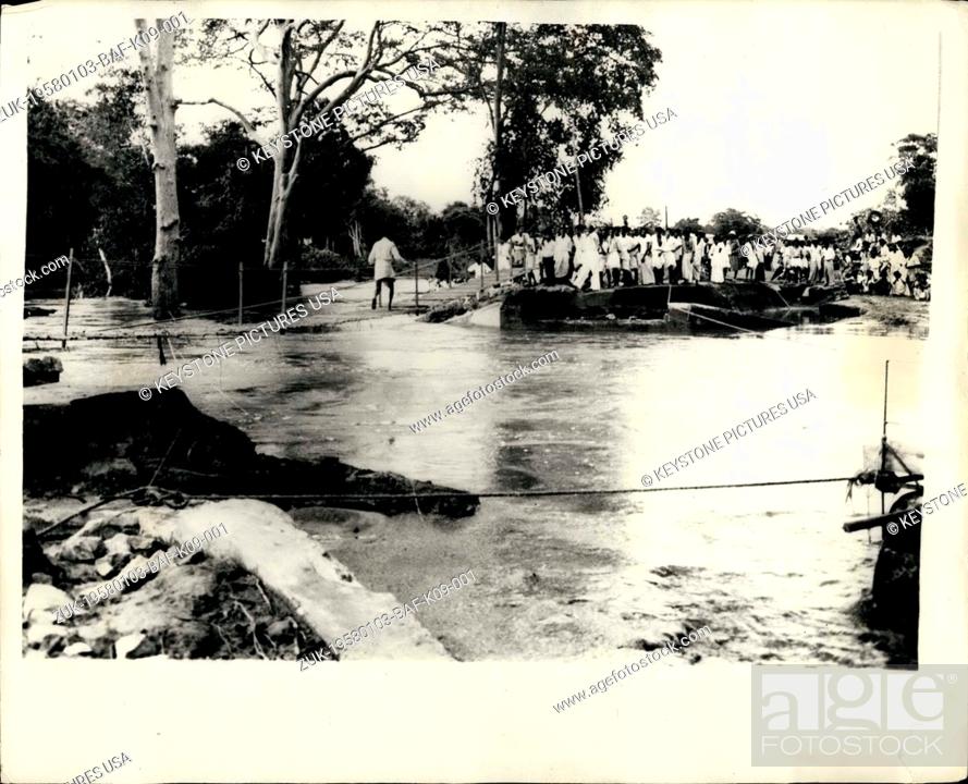 Stock Photo: Jan. 03, 1958 - Hundreds Perish in the Ceylon Floods. Sugar Workers Evacuated over at Temporary Bridge. It is feared that the death role may reach 1.
