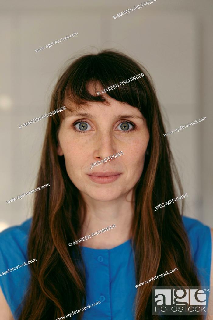 Stock Photo: Mid adult woman with gray eyes and bangs.