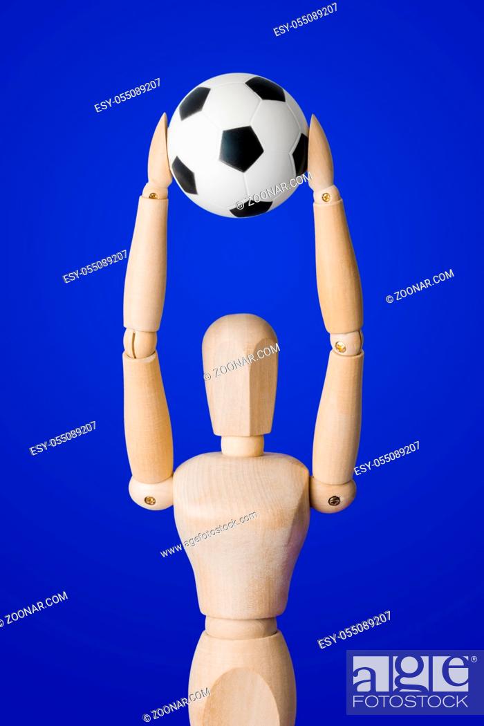 Stock Photo: Football wooden toy figure on blue background.