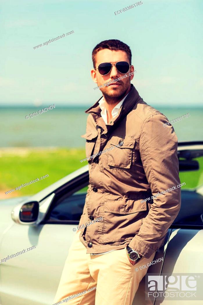 Stock Photo: auto business, transport, travel, leisure and people concept - man near cabriolet car outdoors.