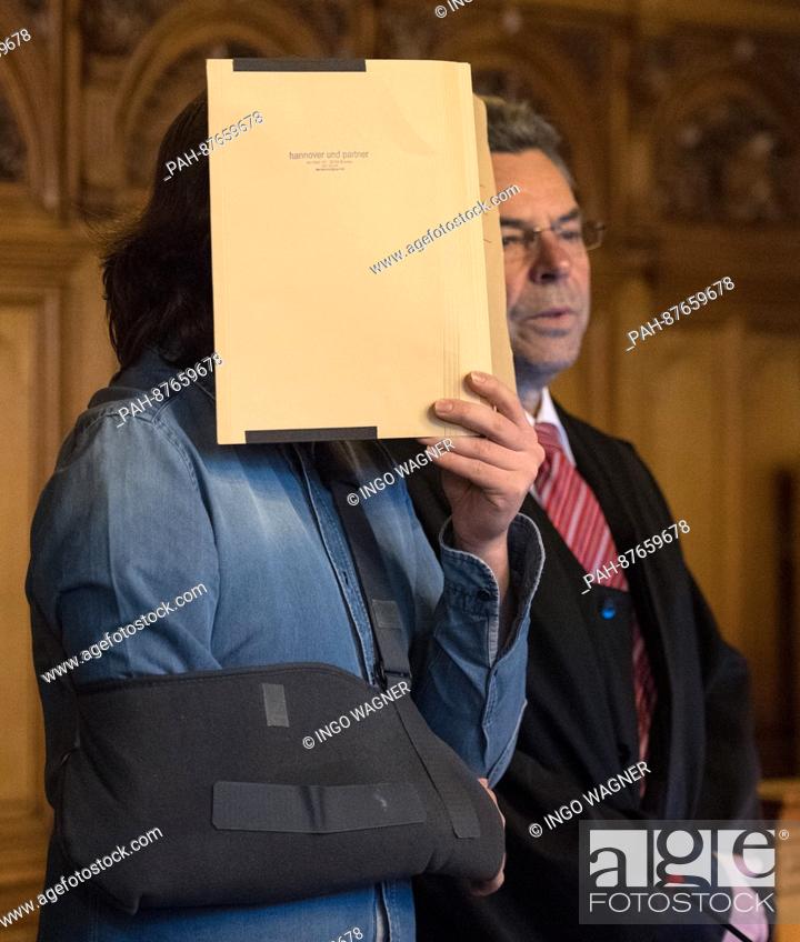 Stock Photo: The defendant in a murder trial (L) hides his face behind a folder in the hearing room of the regional court in Bremen, Germany, 31 January 2017.