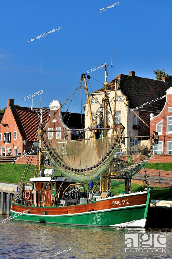 Stock Photo: Crab cutters in the harbor, in front of historical buildings, Greetsiel, Lower Saxony, Germany.