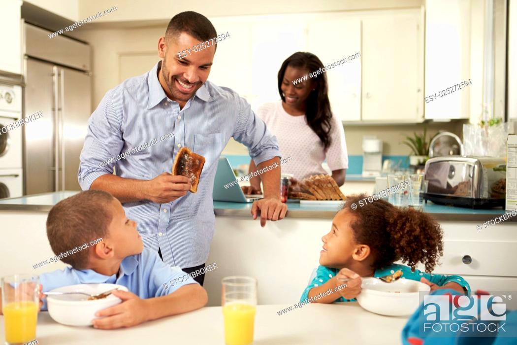 Stock Photo: Family Eating Breakfast At Home Together.