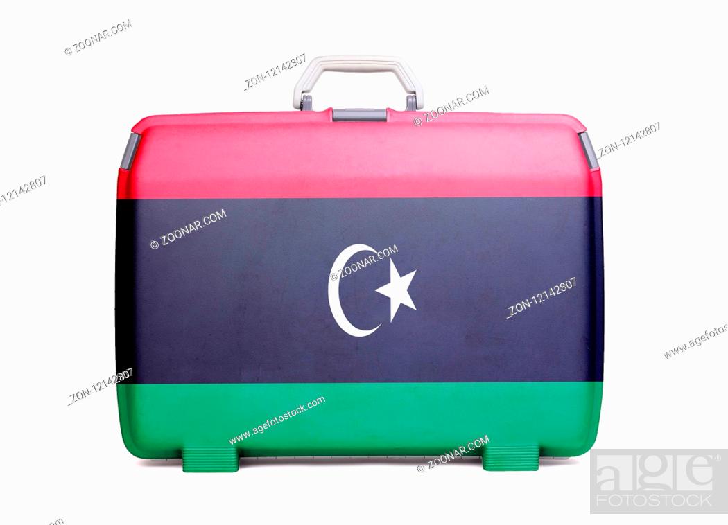 Stock Photo: Used plastic suitcase with stains and scratches, printed with flag, Libya.