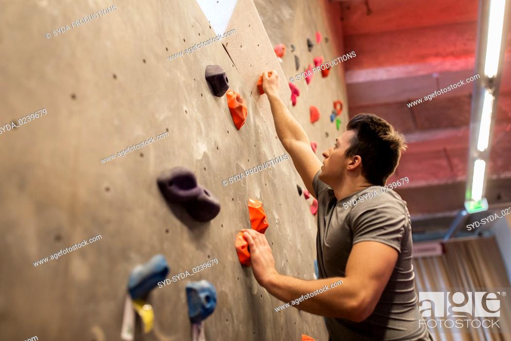 Stock Photo: young man exercising at indoor climbing gym.