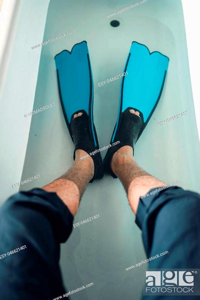 Stock Photo: Funny businessman in flippers sitting on the edge of the bathtub, humor. Business fortune concept.