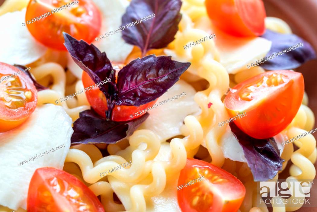 Stock Photo: Fusilli lunghi with cheese and cherry tomatoes.
