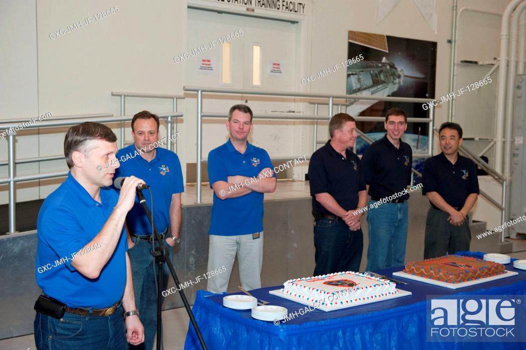 Stock Photo: Russian cosmonaut Andrey Borisenko (left foreground), Expedition 27 flight engineer and Expedition 28 commander, speaks to a crowd during a cake-cutting.