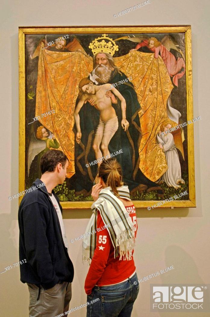 Stock Photo: Young couple looking at The Holy Trinity (The Throne of Mercy), oakwood, France ca. 1420. Bode Museum, Museum Island, Berlin.