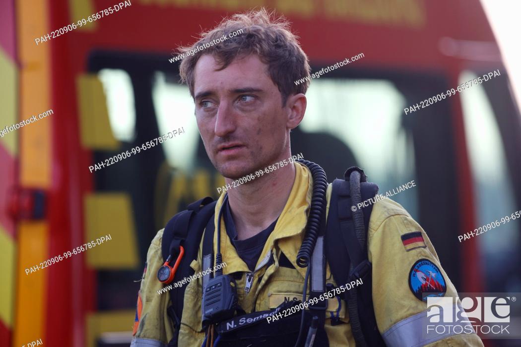 Stock Photo: 06 September 2022, Saxony-Anhalt, Elend: A member of the special unit from the forest fire team, Nico Semsch, returns from the forest fire area in the late.