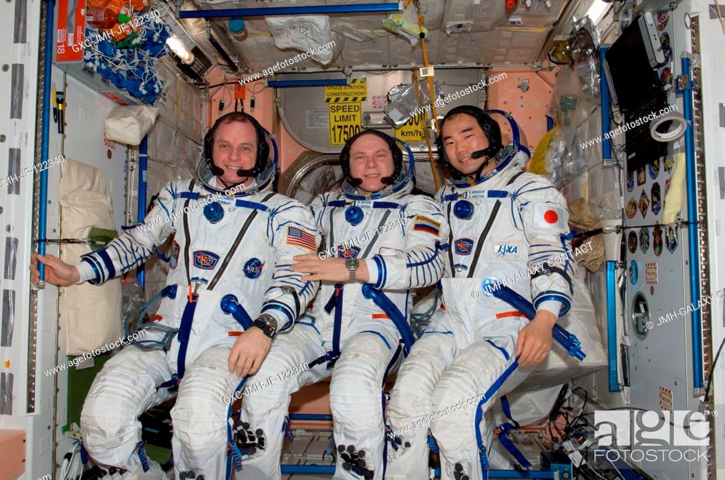 Stock Photo: Attired in their Russian Sokol launch and entry suits, Russian cosmonaut Oleg Kotov (center), Expedition 23 commander; along with NASA astronaut T.J.