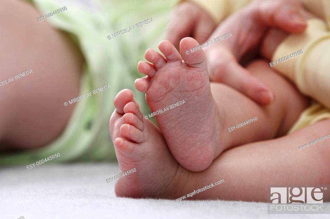Photo de stock: Mother holding her childs feet.