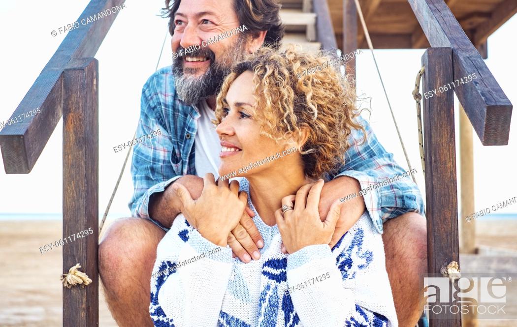Stock Photo: Woman and man smiling outdoor hugging with love. Romantic outdoor leisure activity with young adult couple on vacation. Summer lifestyle people enjoying.