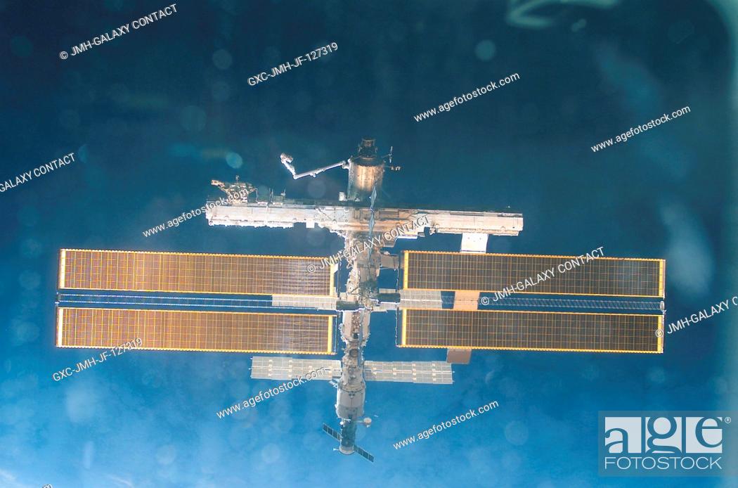 Stock Photo: Backdropped by the blackness of space, this full view of the International Space Station (ISS) was photographed by a crewmember on board the Space Shuttle.