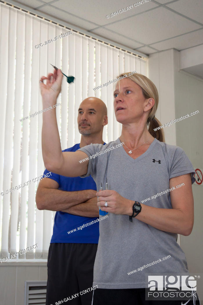 Stock Photo: In the Cosmonaut Hotel crew quarters in Baikonur, Kazakhstan, Expedition 3637 Flight Engineer Karen Nyberg of NASA takes a turn at a game of darts May 22 as.