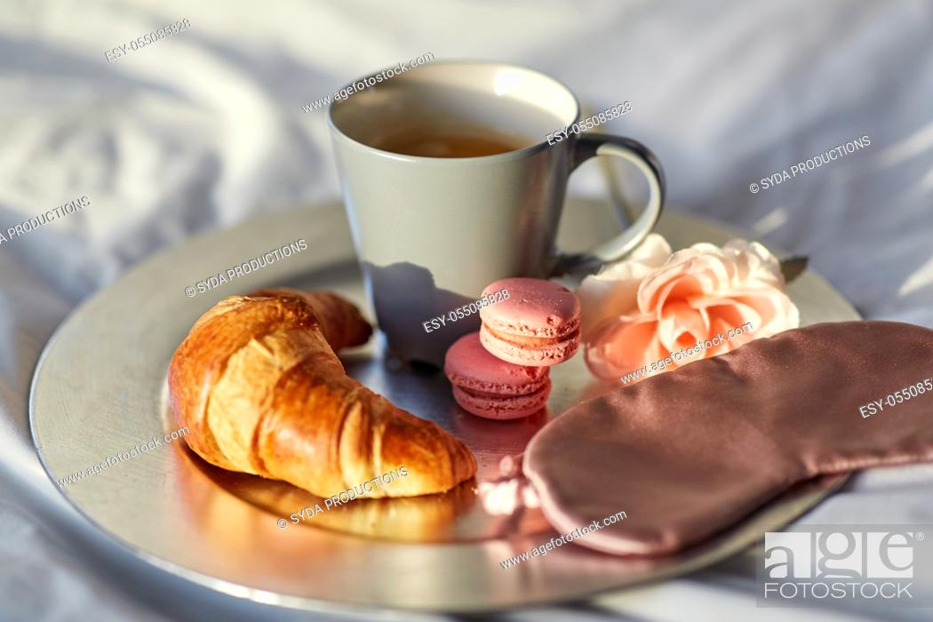 Stock Photo: croissant, coffee and eye sleeping mask in bed.