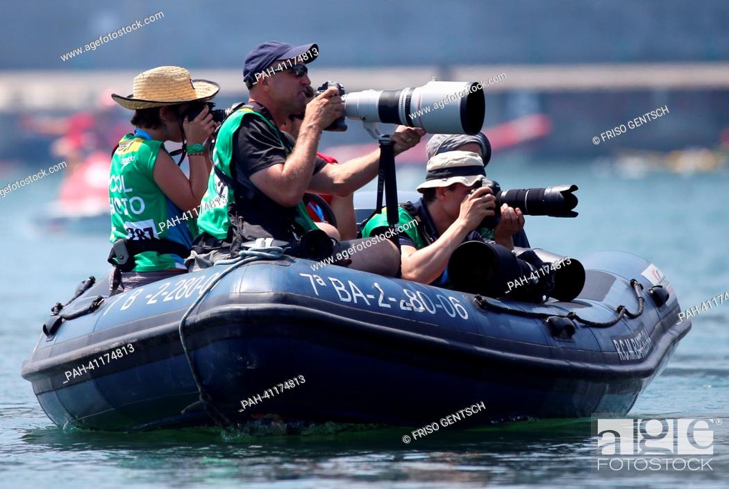 Stock Photo: Photographers take pictures from a boat during the men's 5 km Marathon Open Water event of the 15th FINA Swimming World Championships at Moll de la Fusta on the.