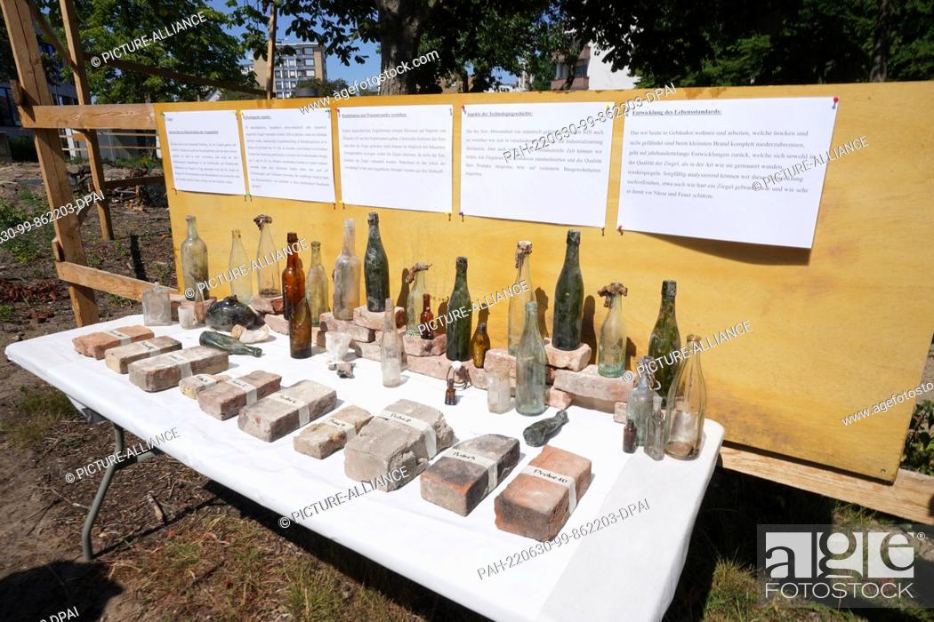 Stock Photo: 30 June 2022, Hamburg: Finds such as glass bottles stand on a table at the excavation site around the main church of St. Trinitatis in Altona.