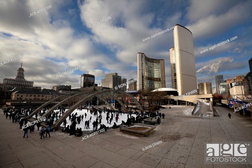 Stock Photo: Skaters outdoors at the Nathan Phillips Square Rink at City Hall in Toronto, Ontario, Canada.