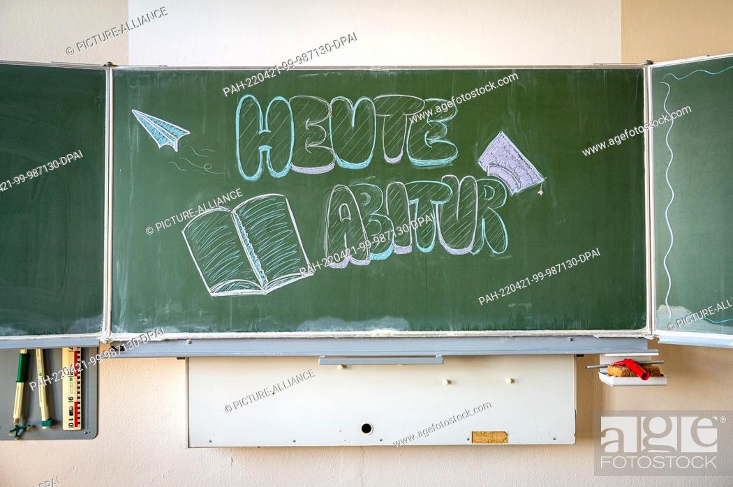 Stock Photo: 21 April 2022, Lower Saxony, Delmenhorst: ILLUSTRATION - ""Abitur today"" is written on a blackboard in a high school classroom.
