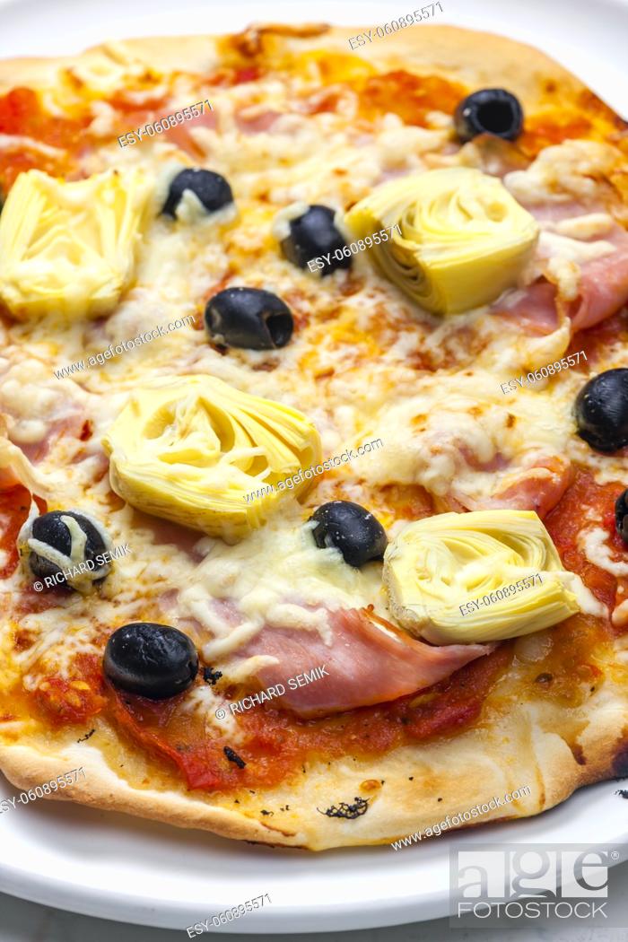 Stock Photo: pizza with ham, black olives and artichokes.