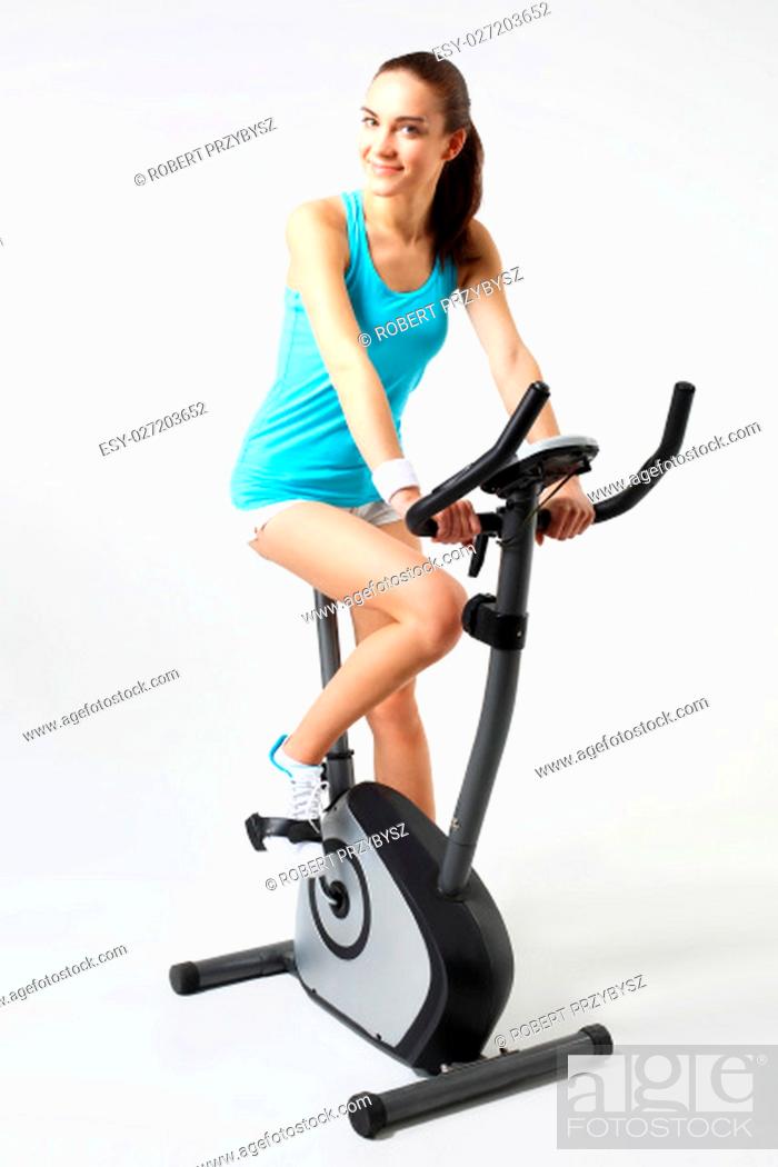 Stock Photo: exercise bike, effective form of exercise.\nexercise on a stationary bike, a woman in a fitness club.