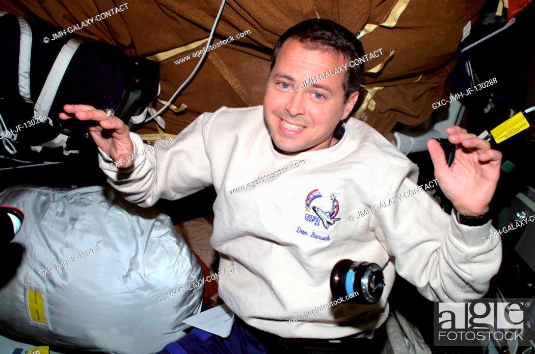 Stock Photo: Astronaut Daniel W. Bursch, Expedition Four flight engineer, is photographed with stowage bags on the mid deck of the Space Shuttle Endeavour.